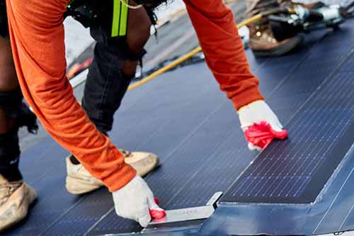 Team member installing solar panels.